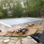 Pool covered by gray swimming pool cover